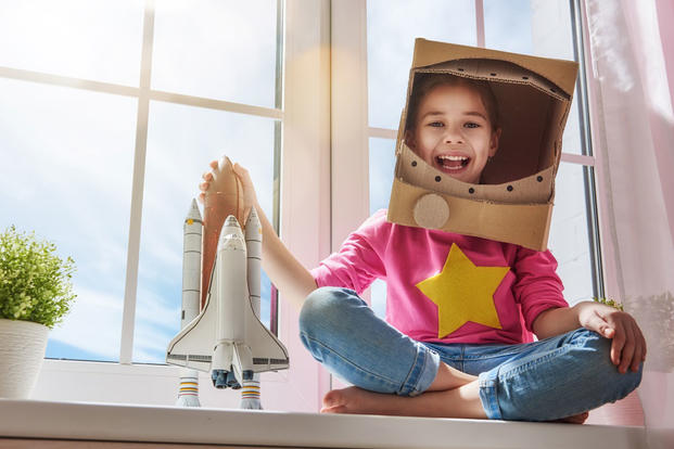 Girl with space shuttle toy