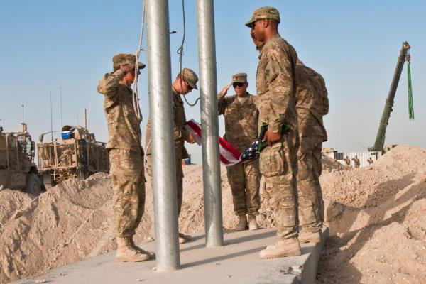 Soldiers retire the U.S. flag as base closure operations come to an end and U.S. troops prepare to leave Forward Operating Base Walton, in Kandahar, Afghanistan. (U.S. Army photo)