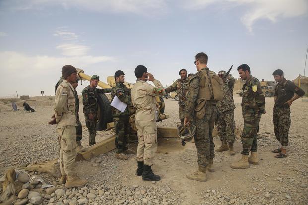 A U.S. Marine adviser with Task Force Southwest speaks with Afghan National Army soldiers with the 2nd Brigade, 215th Corps, on artillery capabilities and tactics at Camp Nolay, Afghanistan, on May 22, 2017. Sgt. Lucas Hopkins/Marine Corps