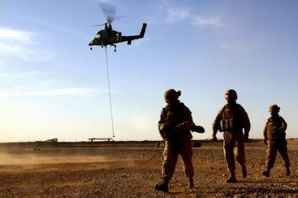 Marines with Combat Logistics Battalion 5 return from familiarizing themselves with the downward thrust of a Kaman K1200, or "K-MAX," unmanned helicopter during initial testing in Helmand province, Afghanistan, May 22.