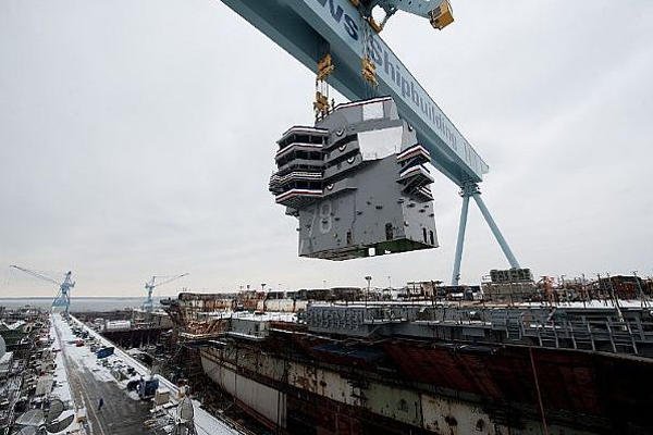 The 555-metric ton island is lowered onto the nuclear-powered aircraft carrier Gerald R. Ford (CVN 78)on Jan. 26, 2013 at Newport News, Va. Navy photo courtesy of Huntington Ingalls Industries.
