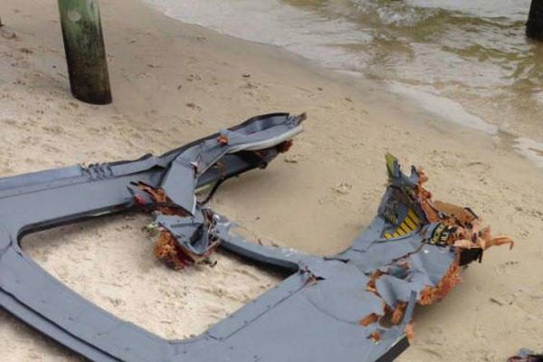 Part of a door assembly of what could be the wreckage of a UH-60 Black Hawk helicopter sits on Riviera Beach in Navarre, Fla., Wednesday, March, 11, 2015. (AP Photo/Northwest Florida Daily News, Jennie McKeon)
