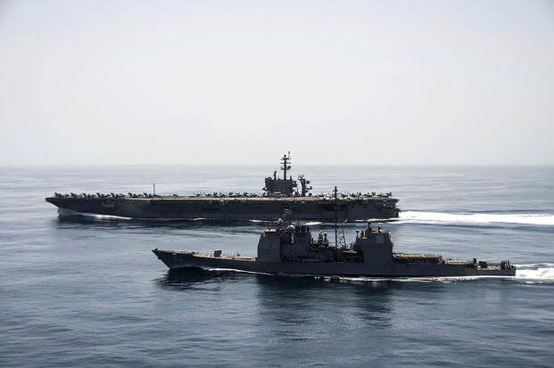 The aircraft carrier USS Theodore Roosevelt (CVN 71) and the guided-missile cruiser USS Normandy (CG 60) operate in the Arabian Sea conducting maritime security operations. 