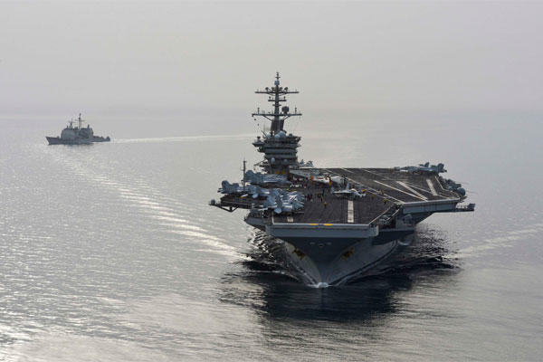 The aircraft carrier USS Theodore Roosevelt (CVN 71) and the guided-missile cruiser USS Normandy (CG) 60 sail in the U.S. 5th Fleet area of operations supporting Operation Inherent Resolve. (U.S. Navy/Mass Communication Specialist Seaman Anna Van Nuys)