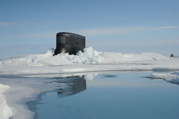 The fast attack submarine USS Seawolf (SSN 21) surfaces through Arctic ice at the North Pole. Seawolf conducted routine Arctic operations. (U.S. Navy)
