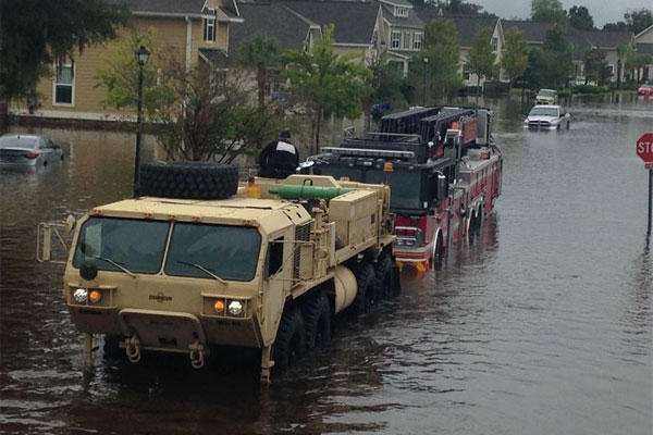 South Carolina National Guardsmen with the 108th Chemical Company and the 1118th Forward Support Company assist with a fire truck stuck in high water in Charleston, S.C., Oct. 4, 2015. (South Carolina Army National Guard photo by Capt. Brian Hare)