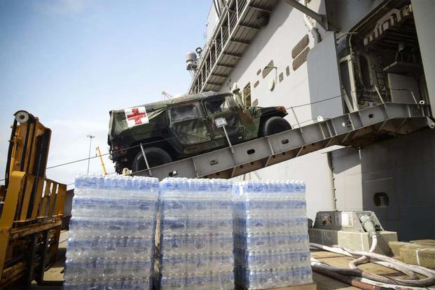 FILE - A medical vehicle attached to the 24th MEU drives aboard the amphibious assault ship USS Iwo Jima (LHD 7). (U.S. Navy photo: Petty Officer 3rd Class Jess E. Toner)
