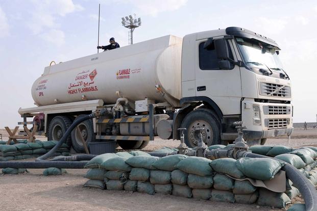 A fuel truck downloads fuel at the bulk fuel farm on Contingency Operating Base Adder, Iraq, Nov. 5, 2011. (Photo Credit: Spc. Anthony Zane, 362nd Mobile Public Affairs Detachment)