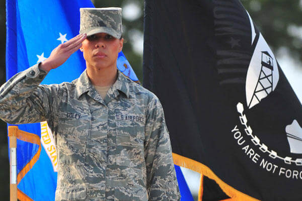 Senior Airman Amber Coley renders a salute as the U.S. military Code of Conduct is recited during the 4th Fighter Wing Prisoner of War/Missing in Action ceremony Sept. 20, 2013, at Seymour Johnson Air Force Base, N.C.