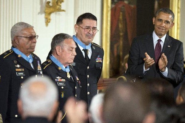 President Obama applauds during a ceremony at the White House, Tuesday, March 18, 2014, honoring Army Staff Sgt. Melvin Morris, from left, Army Sgt. 1st Class Jose Rodela and Army Spc. Santiago Erevia, with the Medal of Honor. (AP Photo/Manuel Balce Cenet
