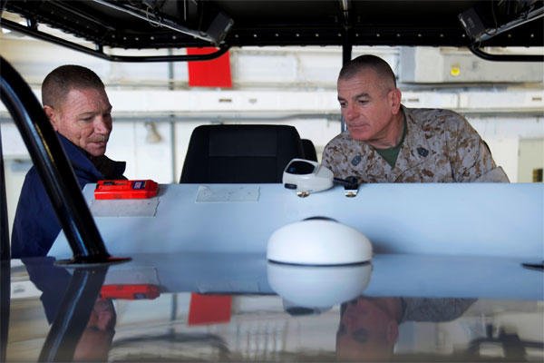 Marine Corps Sgt. Maj. Bryan B. Battaglia, right, senior enlisted advisor to the chairman of the Joint Chiefs of Staff, explores the instrument panel of the Midnight Express, a tactical training boat.