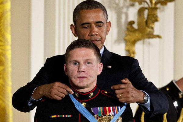 President Barack Obama awards retired Marine Cpl. William "Kyle" Carpenter, the Medal of Honor for conspicuous gallantry, Thursday, June 19, 2014, during a ceremony in the East Room of the White House in Washington. (AP Photo/Jacquelyn Martin)