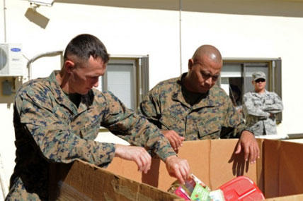 Sgt. Robert Smith (left) and Gunnery Sgt. Omar Hadley (right) assigned to Marine Corps Activity Guam (MCAG) deliver toys to the Salvation Army to support the Toys for Tots foundation. (Photo by Mass Communication Specialist 2nd Class Chelsy Alamina)