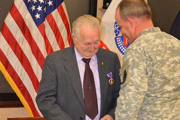 Clifford L. Land received the Purple Heart for wounds he received during hostile enemy fire while stationed in Korea from April 3, 1952 to April 15, 1954 from Lt. Col. Craig S. Besaw. (Jason B. Cutshaw/U.S. Army) 
