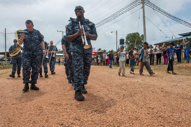 U.S. Navy Petty Officer 2nd Class Vincent Moody and other members of the U.S. Fleet Forces Band ensemble Uncharted Waters walk with area residents in Puerto Cabezas, Nicaragua, May 22, 2015. (U.S. Navy photo/Petty Officer 2nd Class Brittney Cannady)