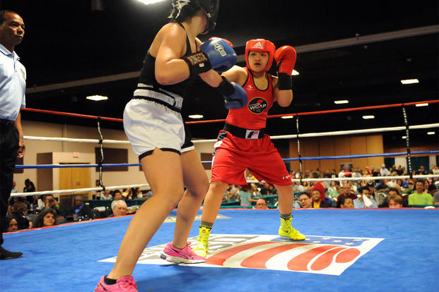 Army Pfc. Rianna Rios, in red, of Fort Carson, Colorado, fights Katina Melendrez in the women's open 132-pound division finale of the 2015 Colorado Golden Gloves Championships at the Crown Plaza Convention Center, March 27, 2015. U.S. Army photo/Tim Hipp