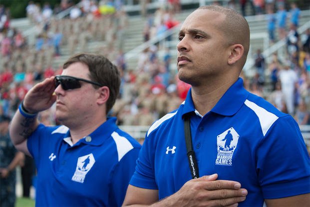 Members of the Air Force team render honors during the playing of the national anthem at the 2015 Department of Defense Warrior Games closing ceremony at Marine Corps Base Quantico, Va., June 28, 2015. DoD photo/Navy Petty Officer 1st Class Daniel Hinton