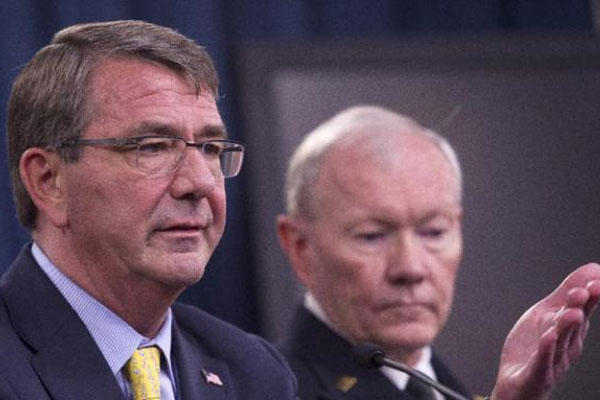 Defense Secretary Ash Carter, accompanied by Joint Chiefs Chairman Gen. Martin Dempsey, gestures during a news conference at the Pentagon, Wednesday, July 1, 2015. (AP Photo/Cliff Owen)
