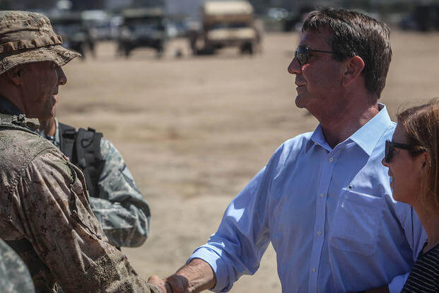 U.S. Secretary of Defense, the honorable Mr. Ashton Carter congratulates a young reconnaissance Marine on a job well done following a combined arms raid aboard Marine Corps Base Camp Pendleton, Calif., Aug. 27, 2015. (Photo: Cpl. Seth Starr)