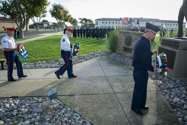 Members of the Marine Corps League Dramis Detachment and a Coast Guard recruit prepare to place wreaths at the foot of the Douglas Munro Memorial, Sunday, Sept. 27, 2015. (Photo by Chief Warrant Officer John Edwards)