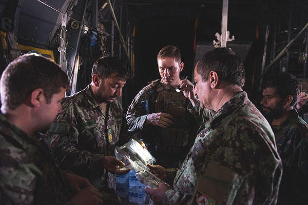 U.S. Air Force Master Sgt. Michael Doane and Afghan airmen complete an AFE inspection during a training session with U.S. Airmen. (U.S. Air Force /Tech. Sgt. Joseph Swafford)