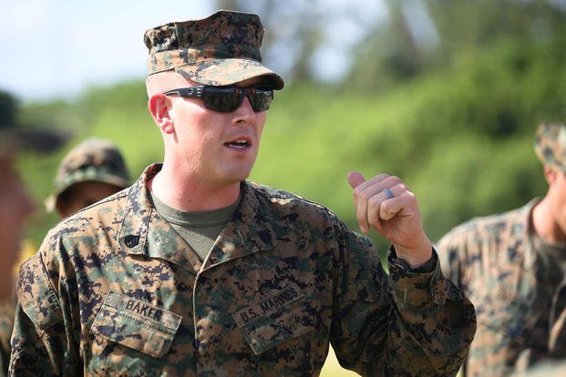 Staff Sgt. Thomas Baker informs the “Trinity” Marines of the plan to move ahead to the forward operating base at the Boondocker Training Area during training exercise Island Viper, Sept. 22, 2015. Photo By: Lance Cpl. Harley Thomas