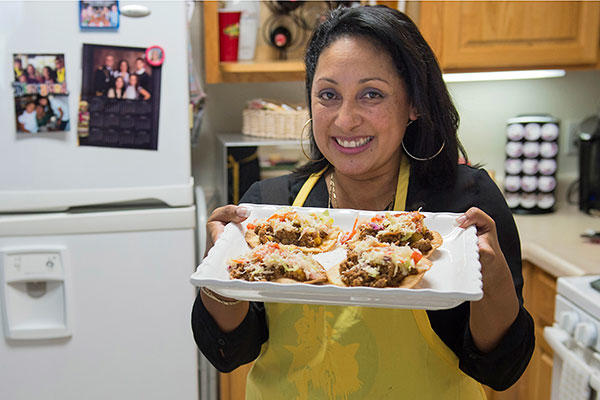 Jenny Lopez-Guerrero, wife of Army Capt. Daniel Lopez-Guerrero, shows off the traditional Honduran patelito she prepared during National Hispanic Heritage month at Fort Lee, Va. (DoD photo by U.S. Navy Petty Officer 3rd Class Timothy Haake)