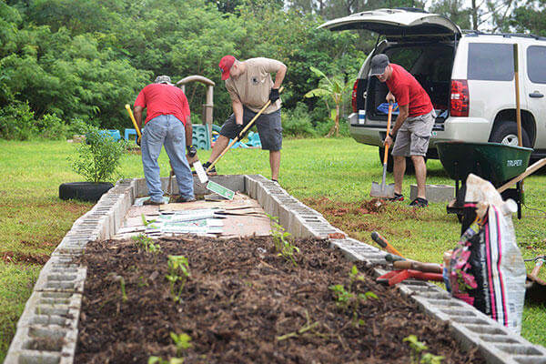 Airmen assigned to the 554th RED HORSE Squadron expand a garden Sept. 26, 2015, at the Guma San Jose Homeless Shelter in Dededo, Guam. (U.S. Air Force/Senior Airman Joshua Smoot)