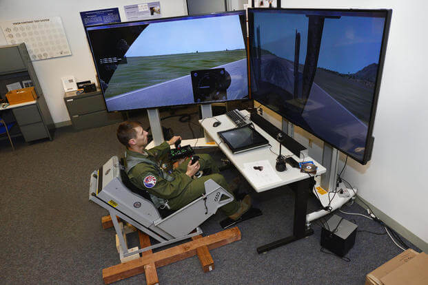 Cadet 1st Class Cody Haggin tests a dynamic motion seat in the Warfighter Effective Research Center at the U.S. Air Force Academy Oct. 23, 2015. (U.S. Air Force Photo/Bill Evans)