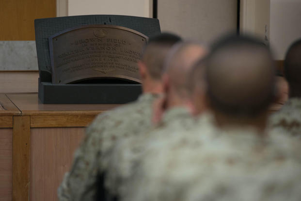 A plaque dedicated to 2nd Lt. Walter V. Brown sits in front of candidates of Officer Candidate School learning about Marine officer history at Marine Corps Base Quantico, Virginia, Nov. 20, 2015. (Photo: Sgt. Eric Keenan)