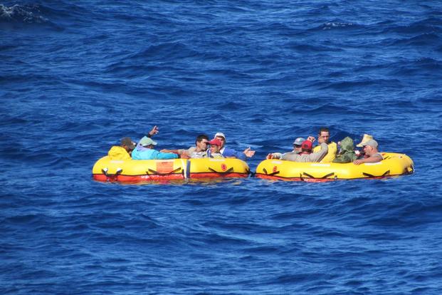 Twelve Cuban migrants drift aboard two life rafts provided by a Coast Guard aircraft that located the migrants aboard a partially submerged migrant vessel 100 miles southwest of Key West, Florida, Dec. 17, 2015. (U.S. Coast Guard photo)