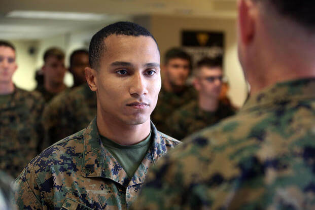 Cpl. Justin McDaniel accepts the Navy and Marine Corps Achievement Medal during an award ceremony at Marine Corps Air Station Cherry Point, N.C., Dec. 3, 2015. (Photo: Cpl. N.W. Huertas)