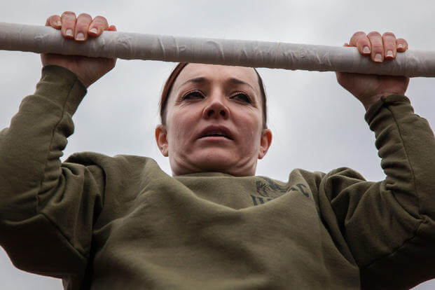 Major Misty Posey demonstrates proper form for pull-ups to Marines at Marine Corps Base Quantico, Virginia, Feb. 19, 2016. (Photo: Sgt. Dylan Bowyer)