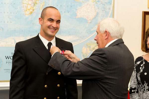 Former Navy Lt. James Zumwalt, left, here having the Bronze Star pinned on by Rep. Frank Wolfe, R-Virginia, in 2012. 
