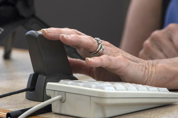 Arlene Wagner, Gold Star mother, places her finger on a scanner for a Gold Star Base Access ID card at Joint Base Andrews, Md., May 1, 2017. (U.S. Air Force photo/Senior Airman Jordyn Fetter)