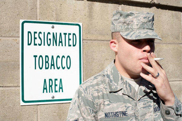 Soldier smokes a cigarette.