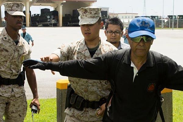 Camp Hansen, Okinawa, Japan - Lance Cpl. Kine Wang searches and detains a simulated suspect. (Photo By: Lance Cpl. Samantha Villarreal)