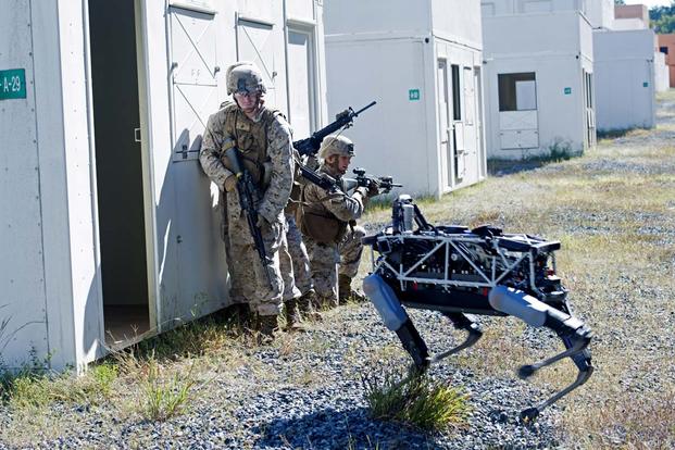 Spot, a quadruped prototype robot, aids Marines in clearing a room during a demonstration at Marine Corps Base Quantico, Va., Sept. 16, 2015. Photo By: Sgt. Eric Keenan