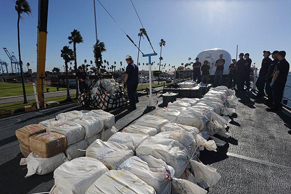 Crew members aboard Coast Guard Cutter Midgett offload an estimated 2,400 pounds of marijuana Nov. 16, 2015. (U.S. Coast Guard/PO1 Sondra-Kay Kneen)