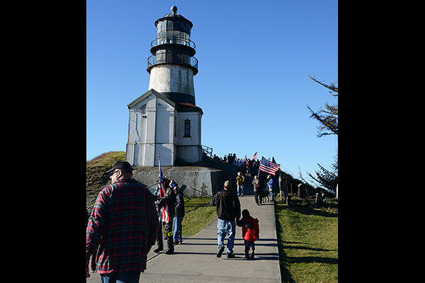 Volunteers, service members and families gather at the Cape Disappointment lighthouse for a memorial ceremony honoring the Coast Guardsmen and fishermen who perished along the Columbia and Quillayute River bars. (U.S. Coast Guard/PO3 Jonathan Klingenberg)