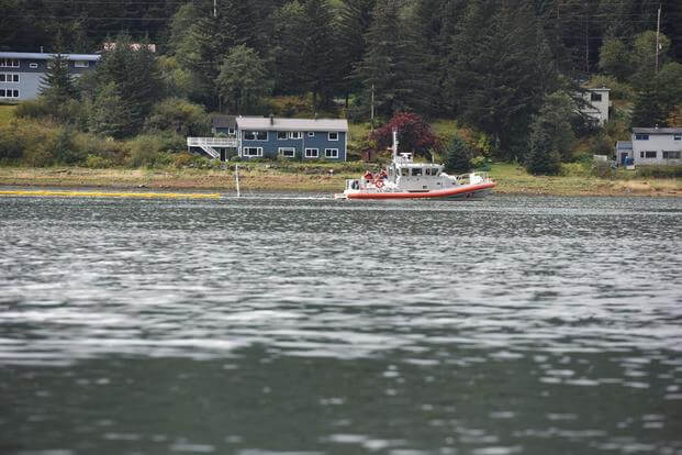 A Coast Guard Station Juneau crew and members of the Sector Juneau response department deploy containment boom around the sunken tug Challenger in Gastineau Channel in Juneau, Alaska, Sept. 13, 2015. (Photo: Petty Officer 2nd Class Grant DeVuyst)