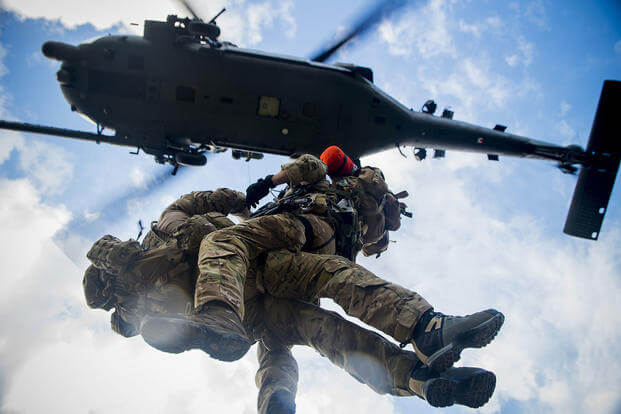 Second Lt. Kendrick Passey and Staff Sgt. Craig Patterson, with 38th Rescue Squadron, get hoisted to an HH-60 Pave Hawk during training at Avon Park Air Force Range, Fla., in 2012.Staff Sgt. Jamal D. Sutter/Air Force
