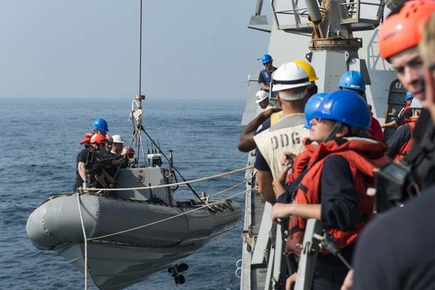 Sailors assigned to the guided-missile destroyer USS Nitze (DDG 94) render assistance to a distressed Iranian vessel. (U.S. Navy photo/Petty Officer 3rd Class Casey J. Hopkins)