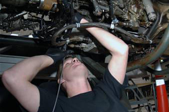 Man underneath engine repair.