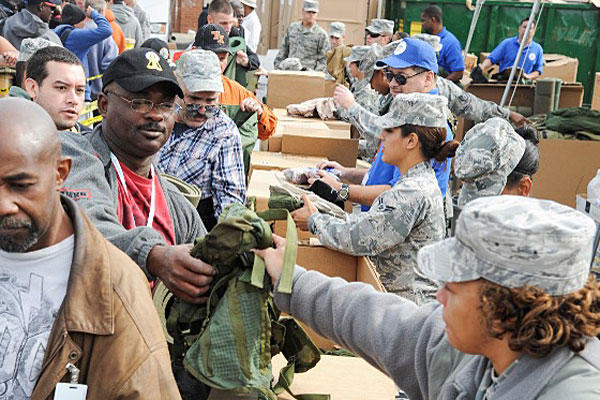 Airmen from the 59th Medical Wing pass out free gear to homeless veterans during the 16th annual American GI Forum Veterans Stand Down. The event was organized by the National Veterans Outreach Program. (U.S. Air Force photo/Staff Sgt. Kevin Iinuma)
