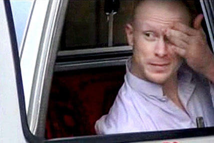 Bowe Bergdahl rubs his head in a still taken from the handover video released by the Taliban.