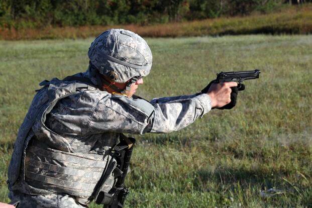 U.S. Army Sgt. Felipe A. Montoya qualifies with the M9 Beretta pistol during a live fire exercise event of the U.S. Army’s Best Warrior Competition, at Fort A.P. Hill, Va., Oct. 6, 2015. (U.S. Army photo by Henrique Luiz de Holleben)