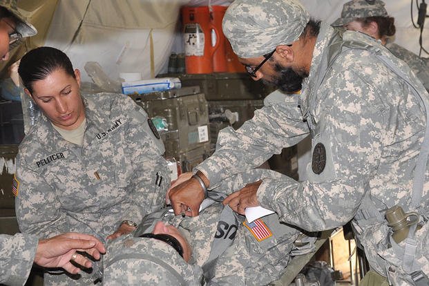 In 2010, Capt. (Dr.) Tejdeep Singh Rattan checks on a patient during an exercise at the Basic officer Course at Camp Bullis. In a feature on Rattan, the Army said his beard and turban didn't interfere with a gas mask and Kevlar helmet. Steve Elliott/Army