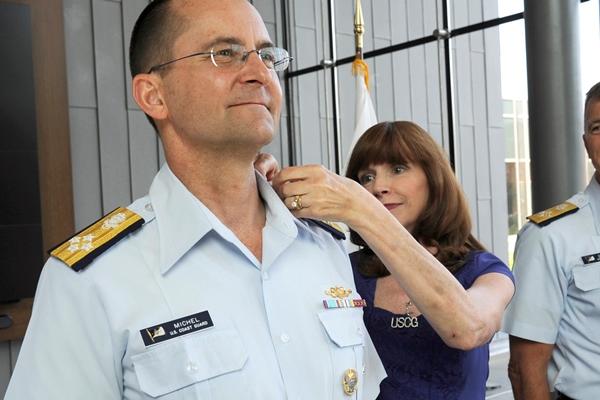 Adm. Charles Michel, vice commandant of the Coast Guard, gets his new shoulderboard for admiral from his wife, Claudia, during a ceremony at the service's headquarters in Washington, D.C., on June 1, 2016. (Photo by Kyle Niemi/U.S. Coast Guard)