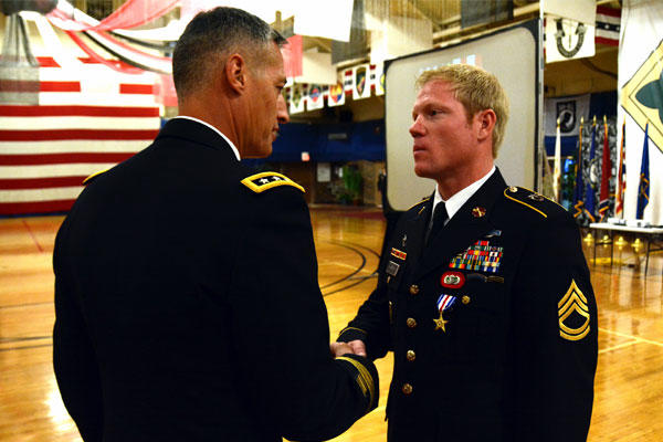 Sgt. 1st Class Richard Harris (right) shakes hands with Lt. Gen. Ken Tovo, commander of U.S. Army Special Operations Command, after receiving the Silver Star Medal on June 3 at Fort Carson, Colo. (US Army photo/Jeffrey Smith)